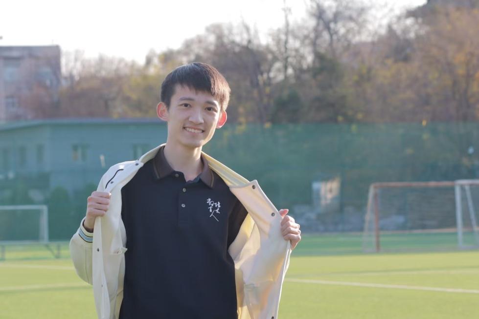 A person holding a jacket
Description automatically generated