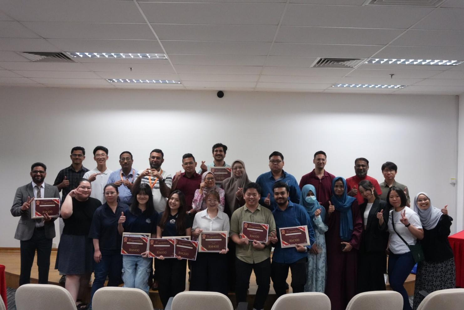 A group of people holding signs
Description automatically generated